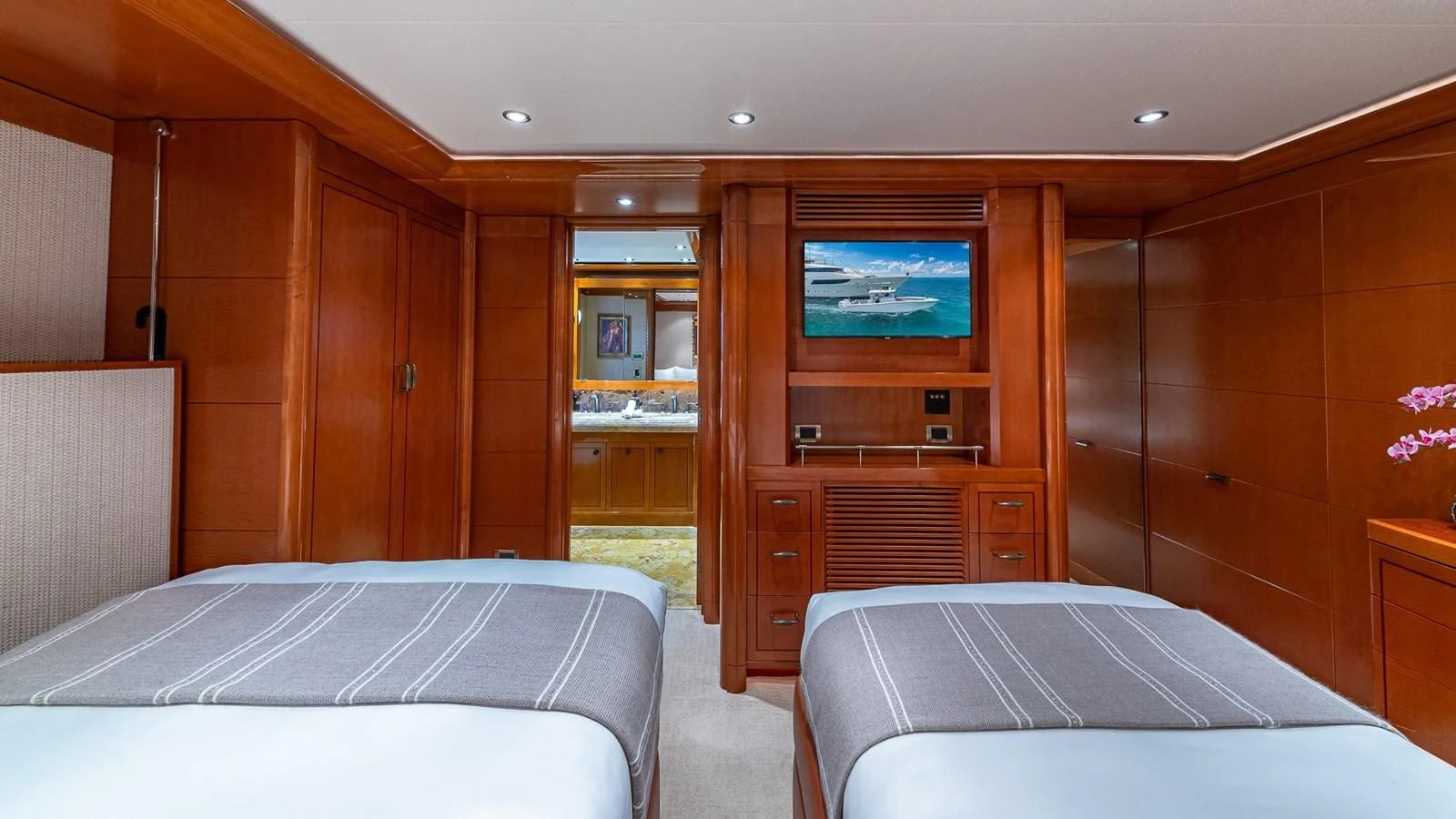 a room with a bed and a tv on the wall aboard AS YOU WISH Yacht for Sale