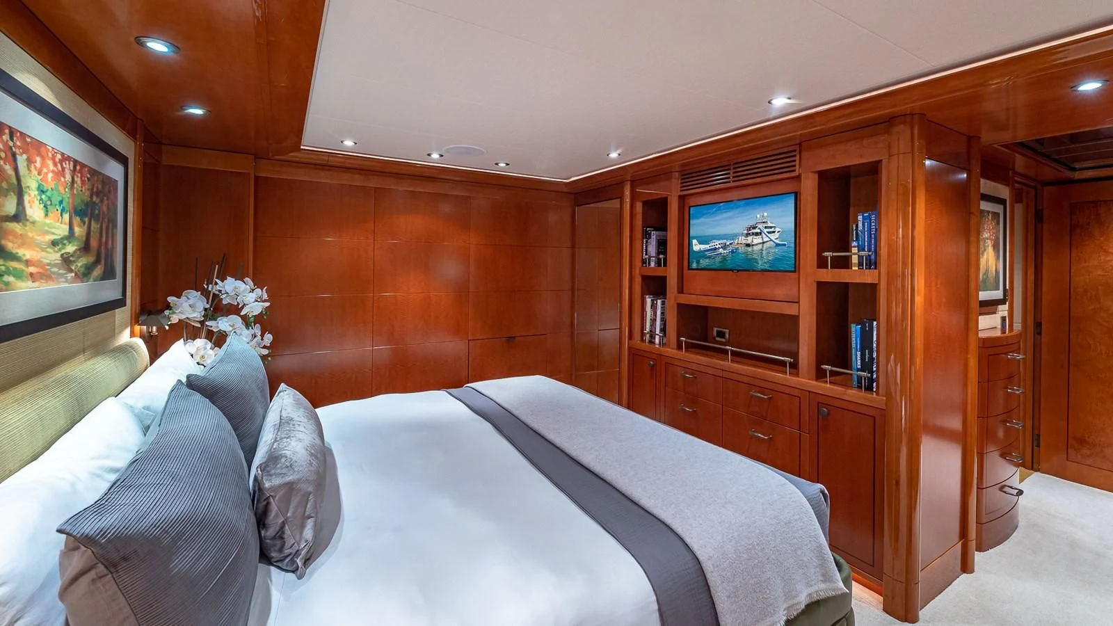 a bedroom with a bed and a television aboard AS YOU WISH Yacht for Sale