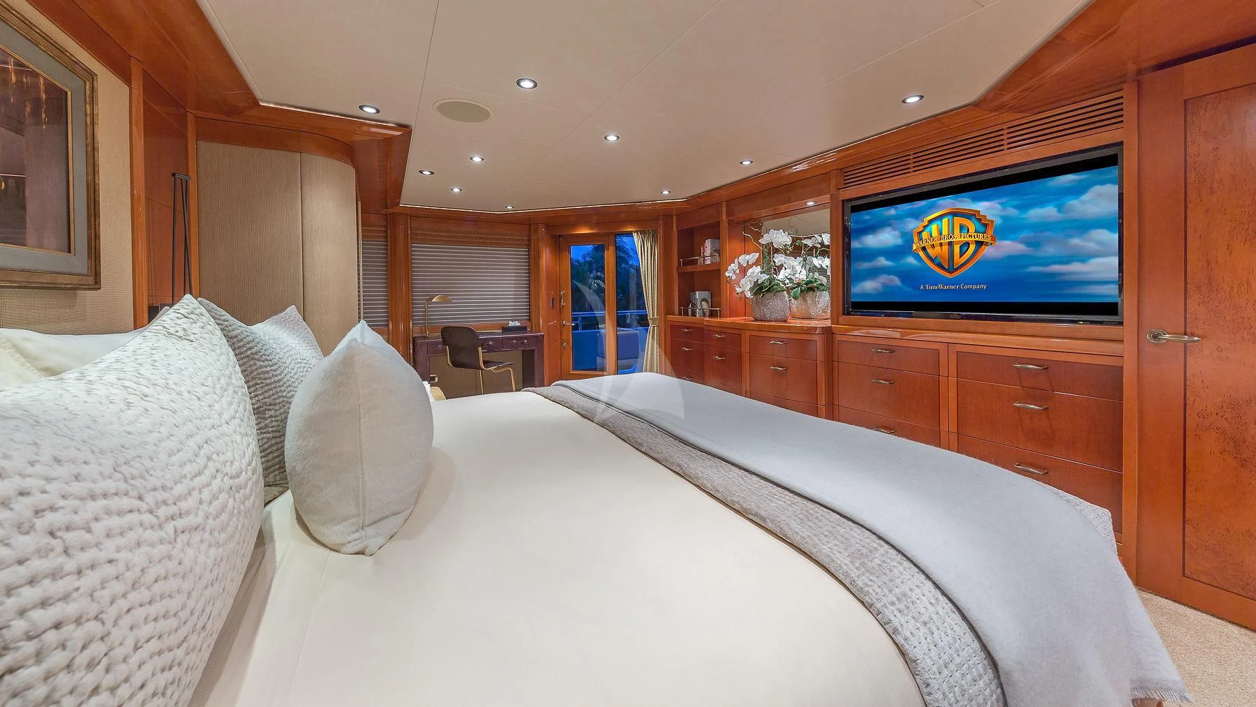 a bed with pillows and a television in a room aboard AS YOU WISH Yacht for Sale
