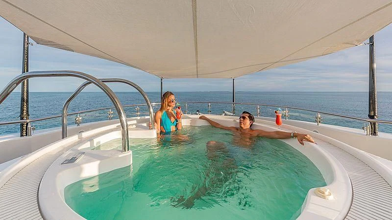 a man and woman in a pool aboard AS YOU WISH Yacht for Sale
