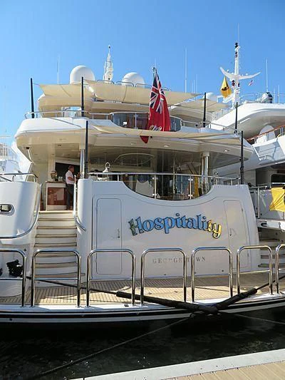 a boat with a flag on the front aboard AS YOU WISH Yacht for Sale