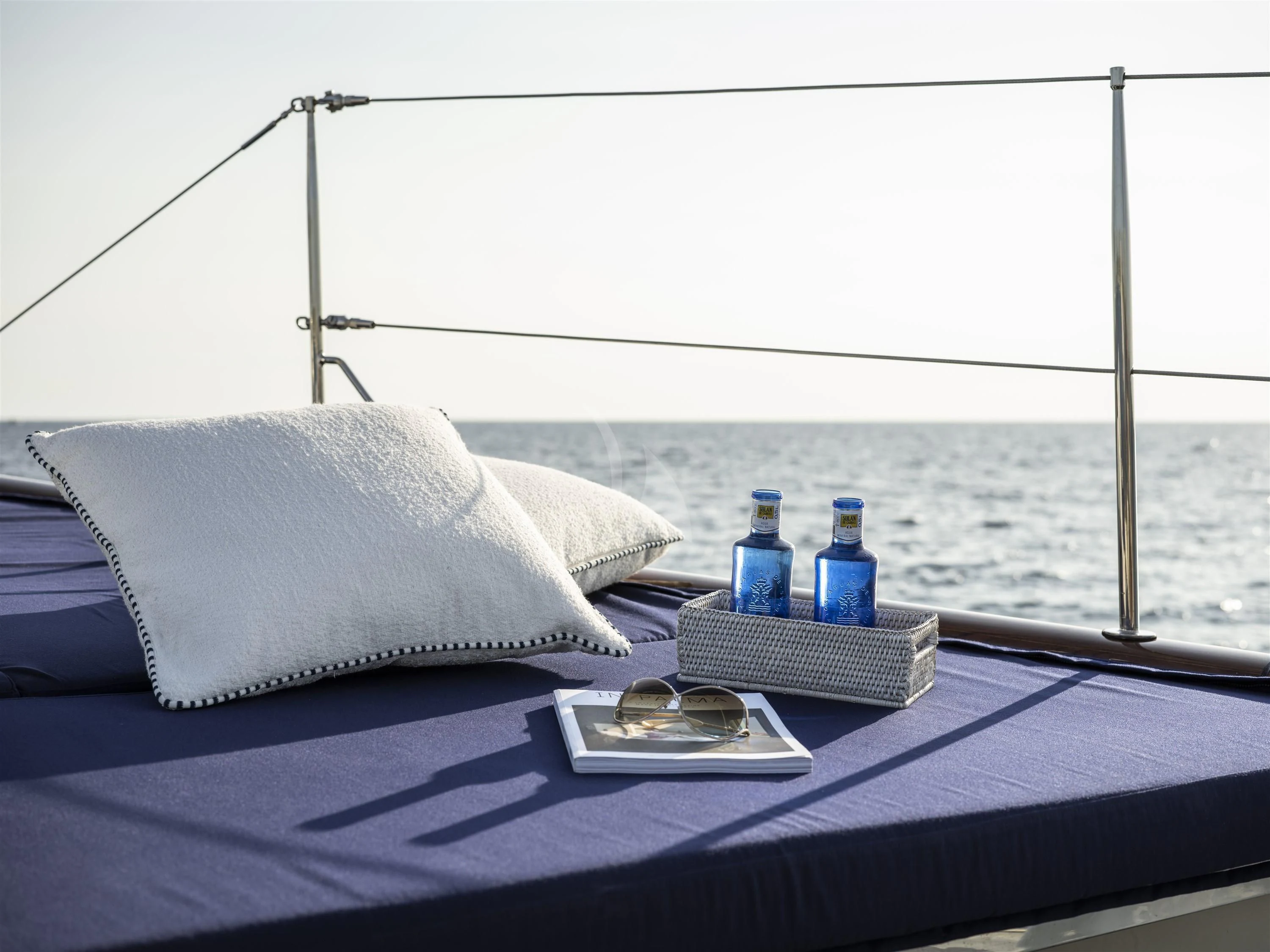 a bed with a blue bottle and a white pillow on it aboard ALEXA OF LONDON Yacht for Sale
