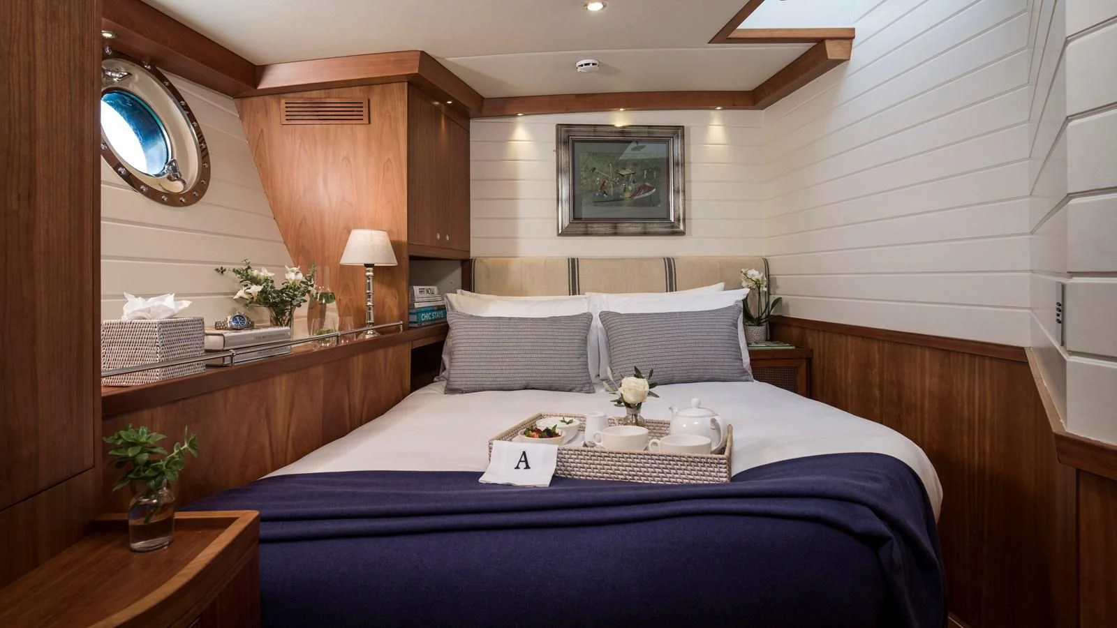 a bed with a blue sheet aboard ALEXA OF LONDON Yacht for Sale