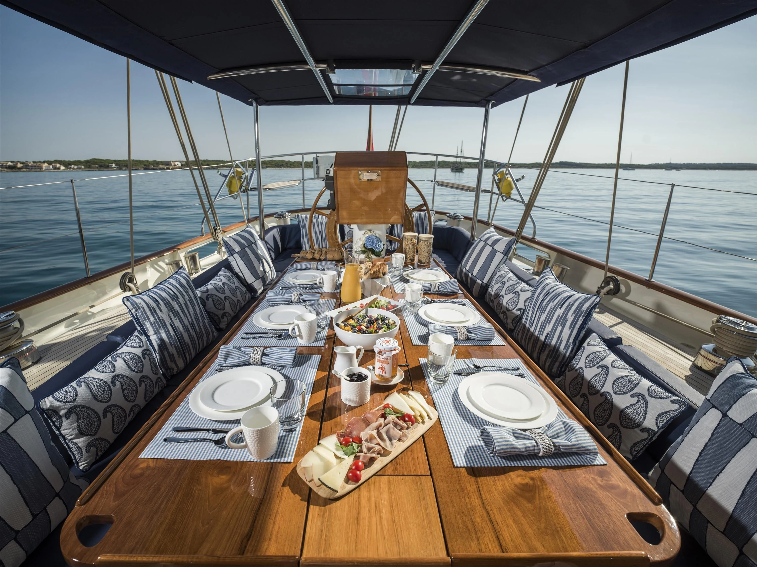 a table with plates and cups on it aboard ALEXA OF LONDON Yacht for Sale