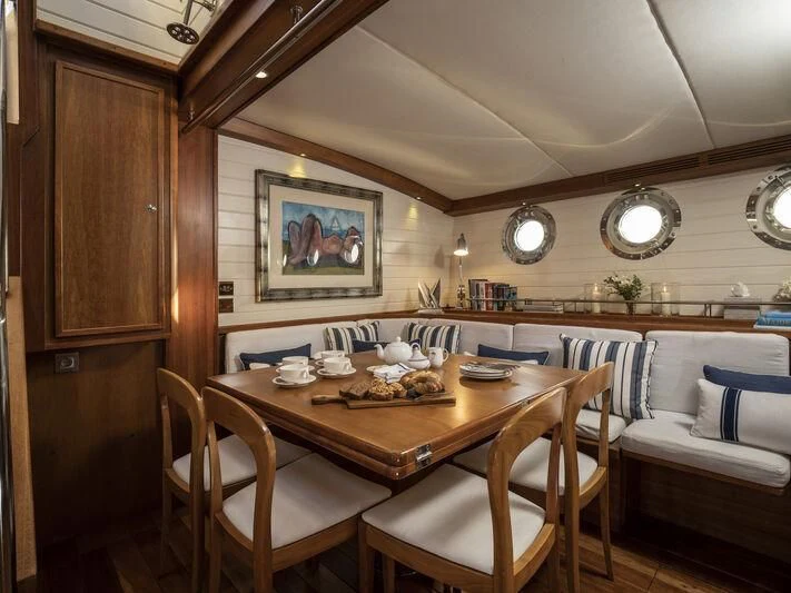 a dining table in a cabin aboard ALEXA OF LONDON Yacht for Sale