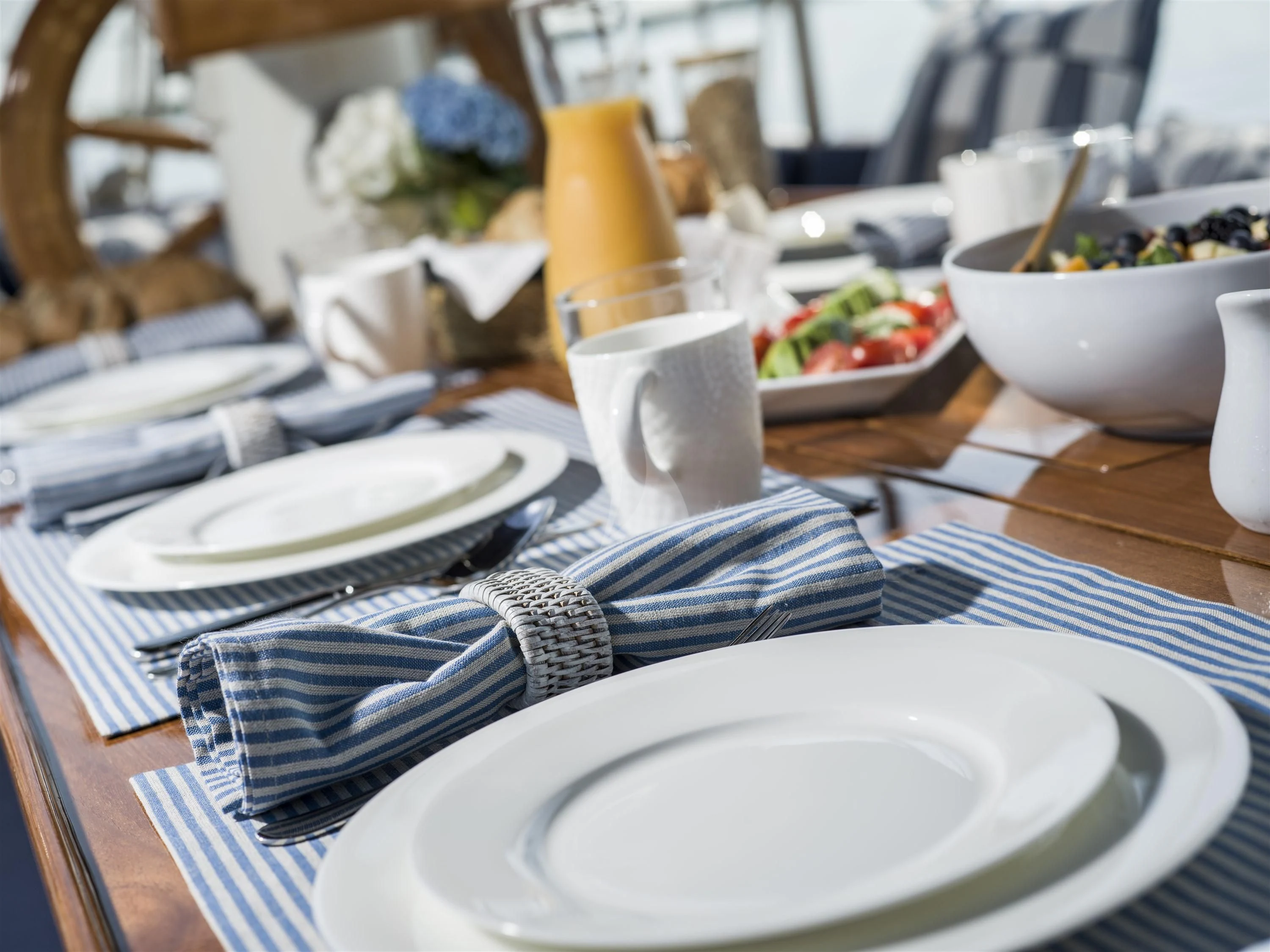 a table with plates and bowls of food on it aboard ALEXA OF LONDON Yacht for Sale