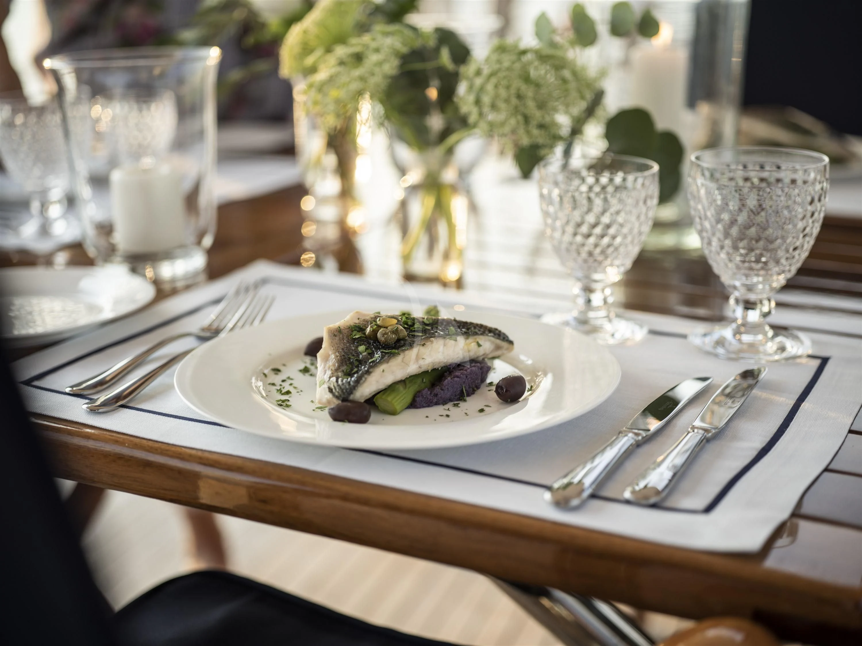 a plate of food and glasses aboard ALEXA OF LONDON Yacht for Sale