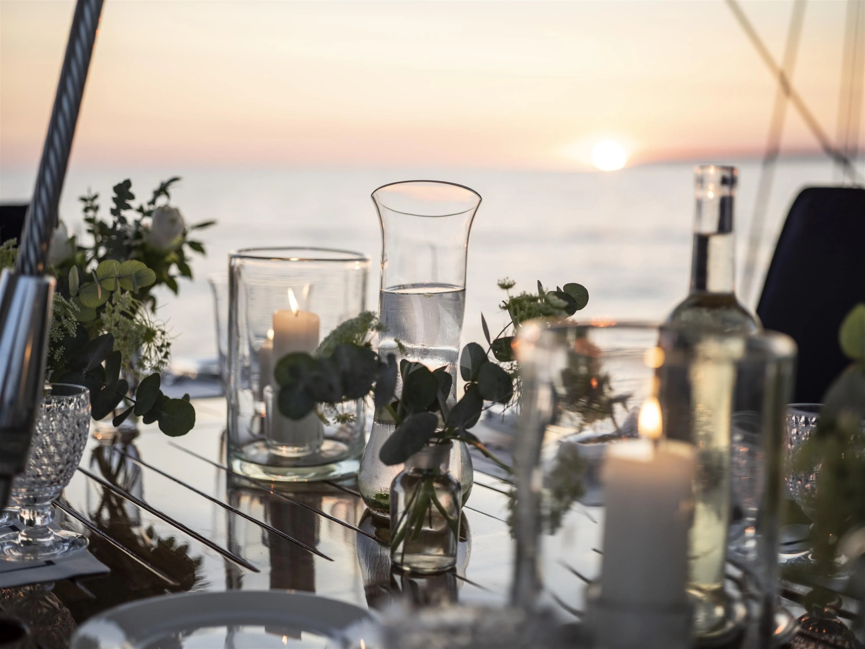 a group of candles and flowers on a table aboard ALEXA OF LONDON Yacht for Sale