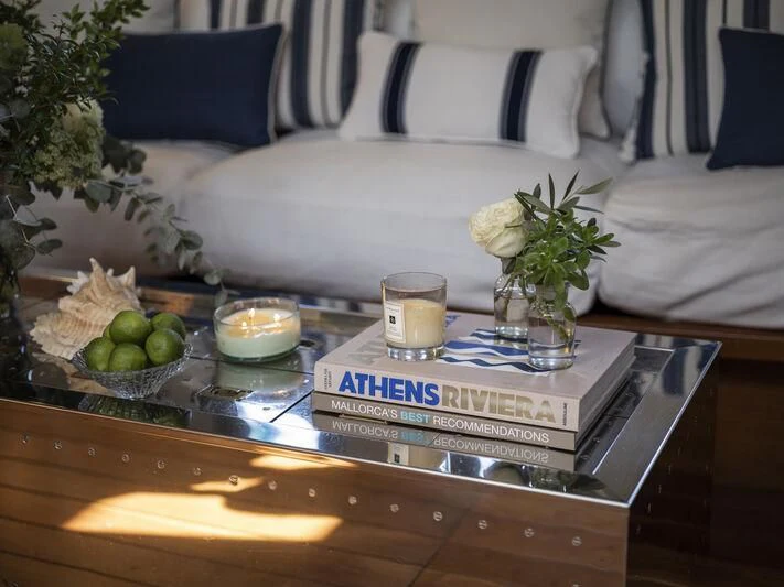 a table with a glass of beer and a box of fruit on it aboard ALEXA OF LONDON Yacht for Sale