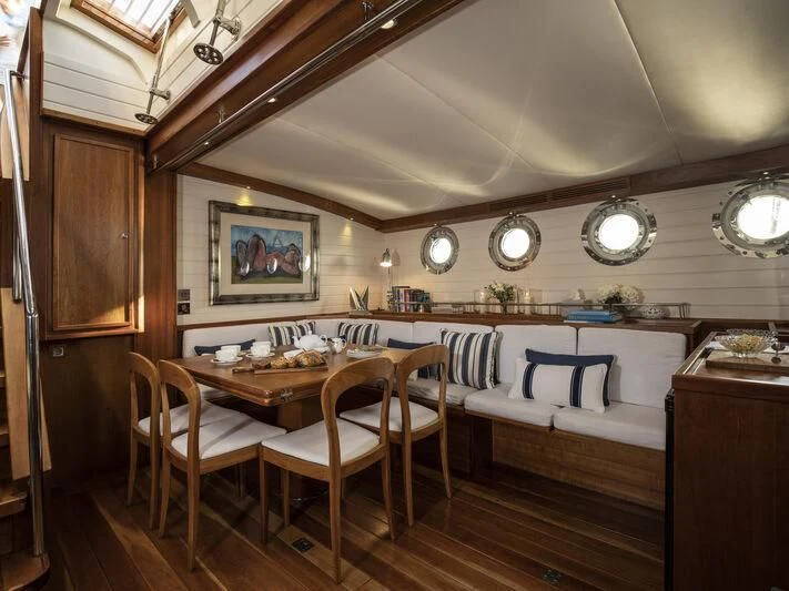 a room with a table and chairs aboard ALEXA OF LONDON Yacht for Sale