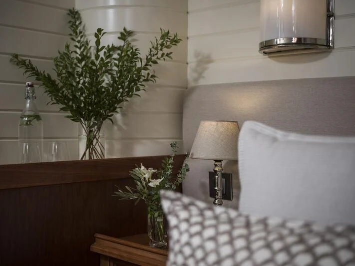 a vase of flowers on a table aboard ALEXA OF LONDON Yacht for Sale