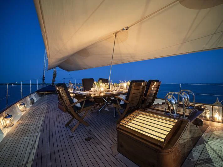 a table and chairs on a deck aboard ALEXA OF LONDON Yacht for Sale