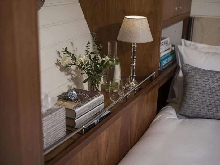 a shelf with a lamp and a book on it aboard ALEXA OF LONDON Yacht for Sale