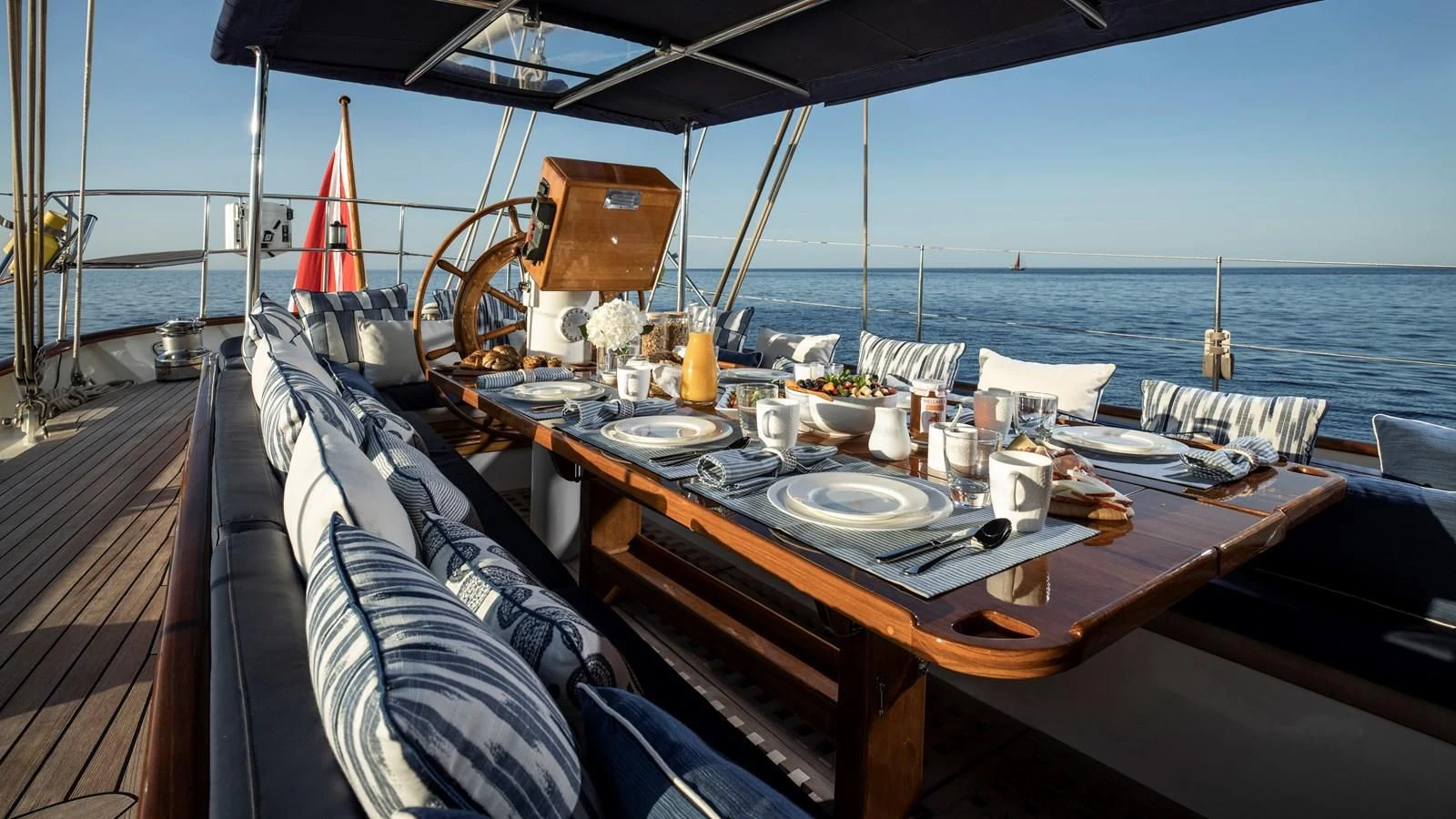 a boat with a table and chairs on it aboard ALEXA OF LONDON Yacht for Sale