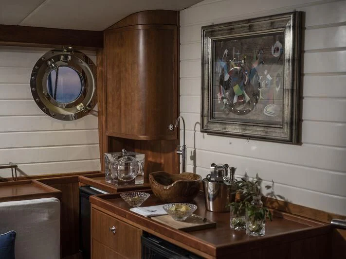 a kitchen with a mirror and a vase on the counter aboard ALEXA OF LONDON Yacht for Sale