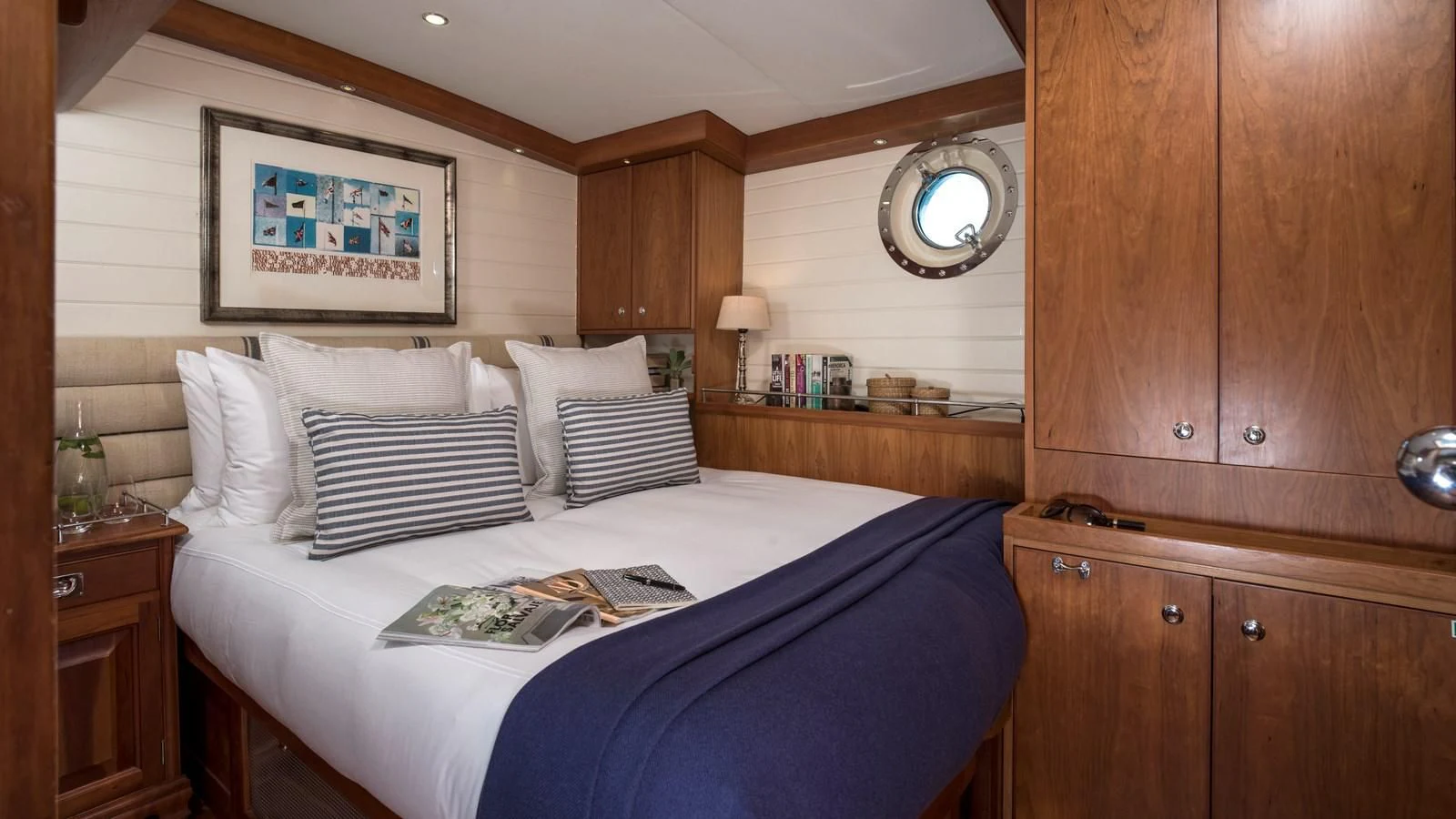 a bed with a blue sheet aboard ALEXA OF LONDON Yacht for Sale