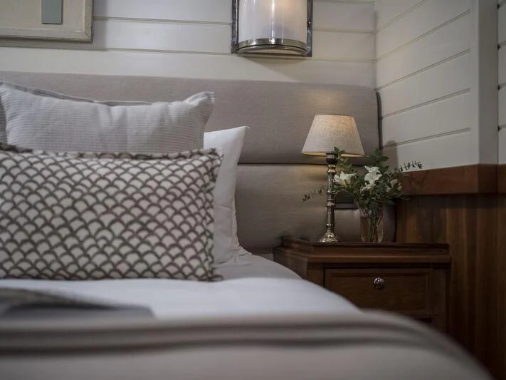 a bed with a white pillow and a white pillow aboard ALEXA OF LONDON Yacht for Sale