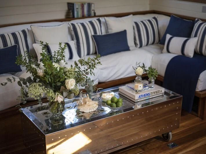 a table with flowers and a vase on it aboard ALEXA OF LONDON Yacht for Sale