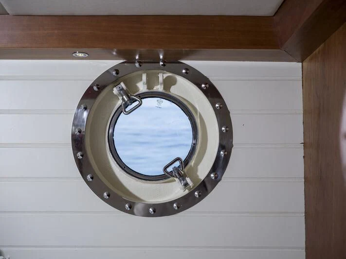 a round mirror on a white wall aboard ALEXA OF LONDON Yacht for Sale