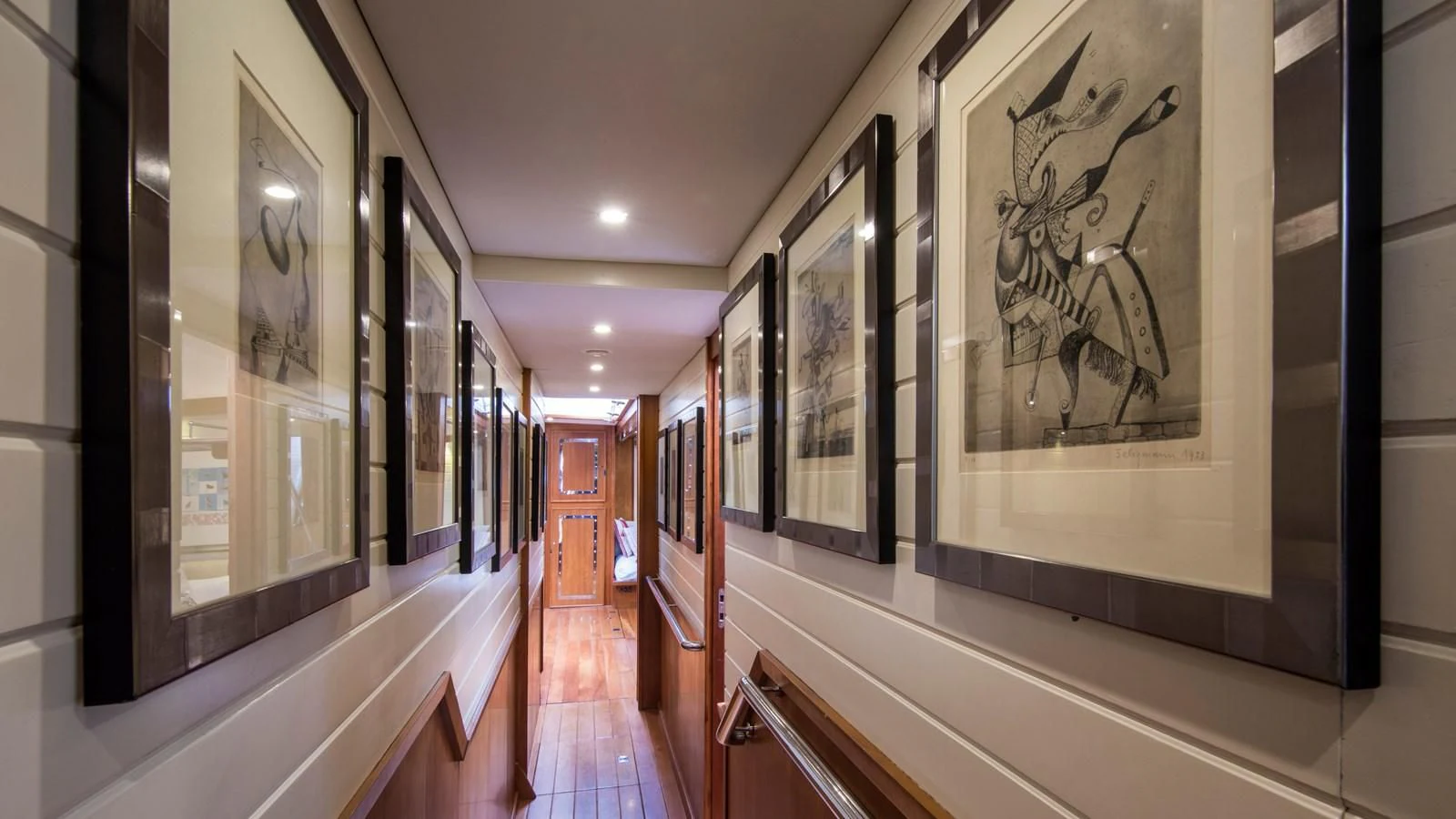 a hallway with art on the walls aboard ALEXA OF LONDON Yacht for Sale