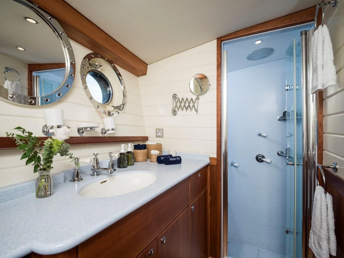 a bathroom with a shower and sink aboard ALEXA OF LONDON Yacht for Sale