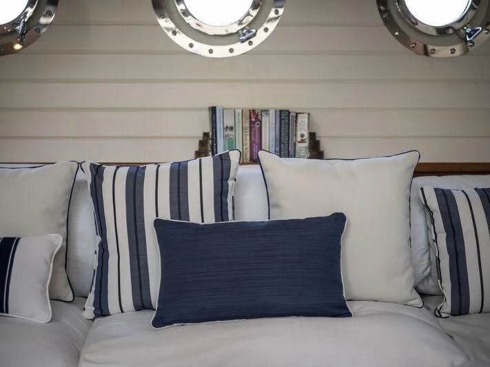 a white couch with pillows aboard ALEXA OF LONDON Yacht for Sale