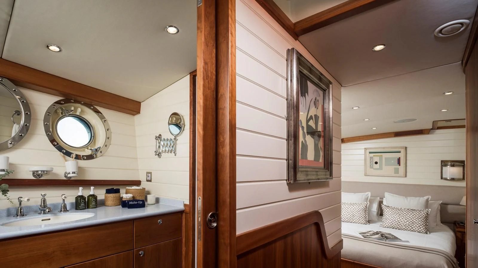 a room with a bed and a mirror aboard ALEXA OF LONDON Yacht for Sale