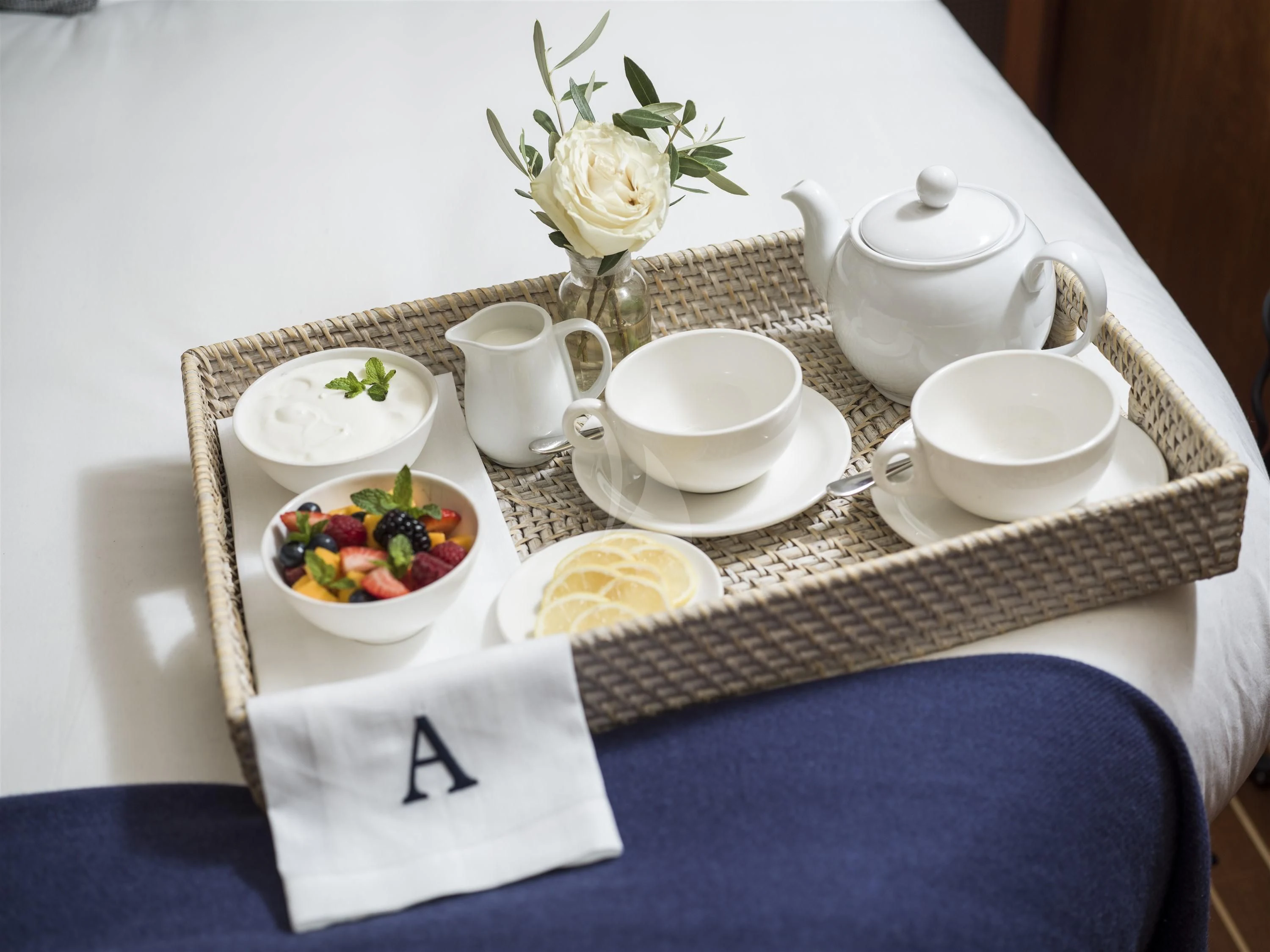 a tray with tea cups and saucers on it aboard ALEXA OF LONDON Yacht for Sale