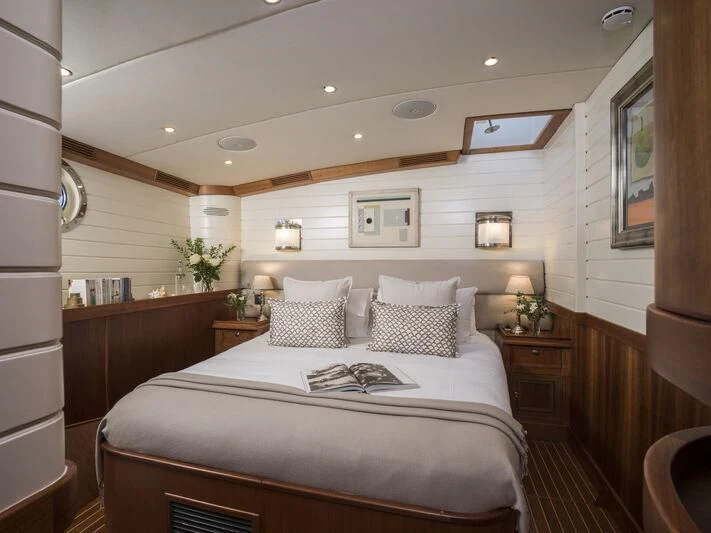a bedroom with a large bed aboard ALEXA OF LONDON Yacht for Sale