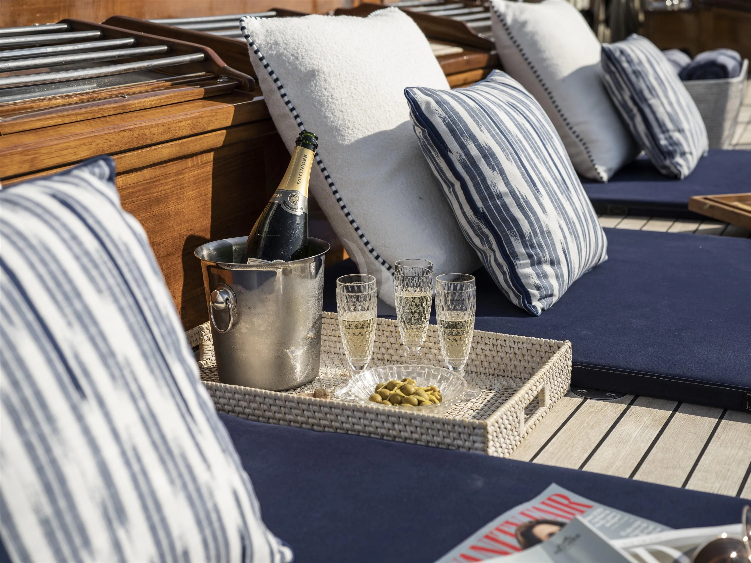 a table with a glass of wine and a tray of food aboard ALEXA OF LONDON Yacht for Sale