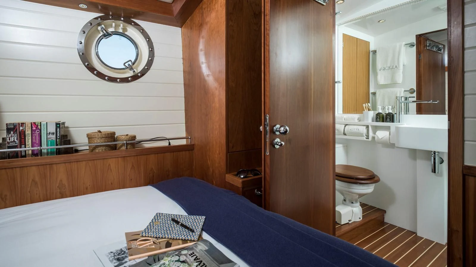 a bedroom with a bed and a sink aboard ALEXA OF LONDON Yacht for Sale