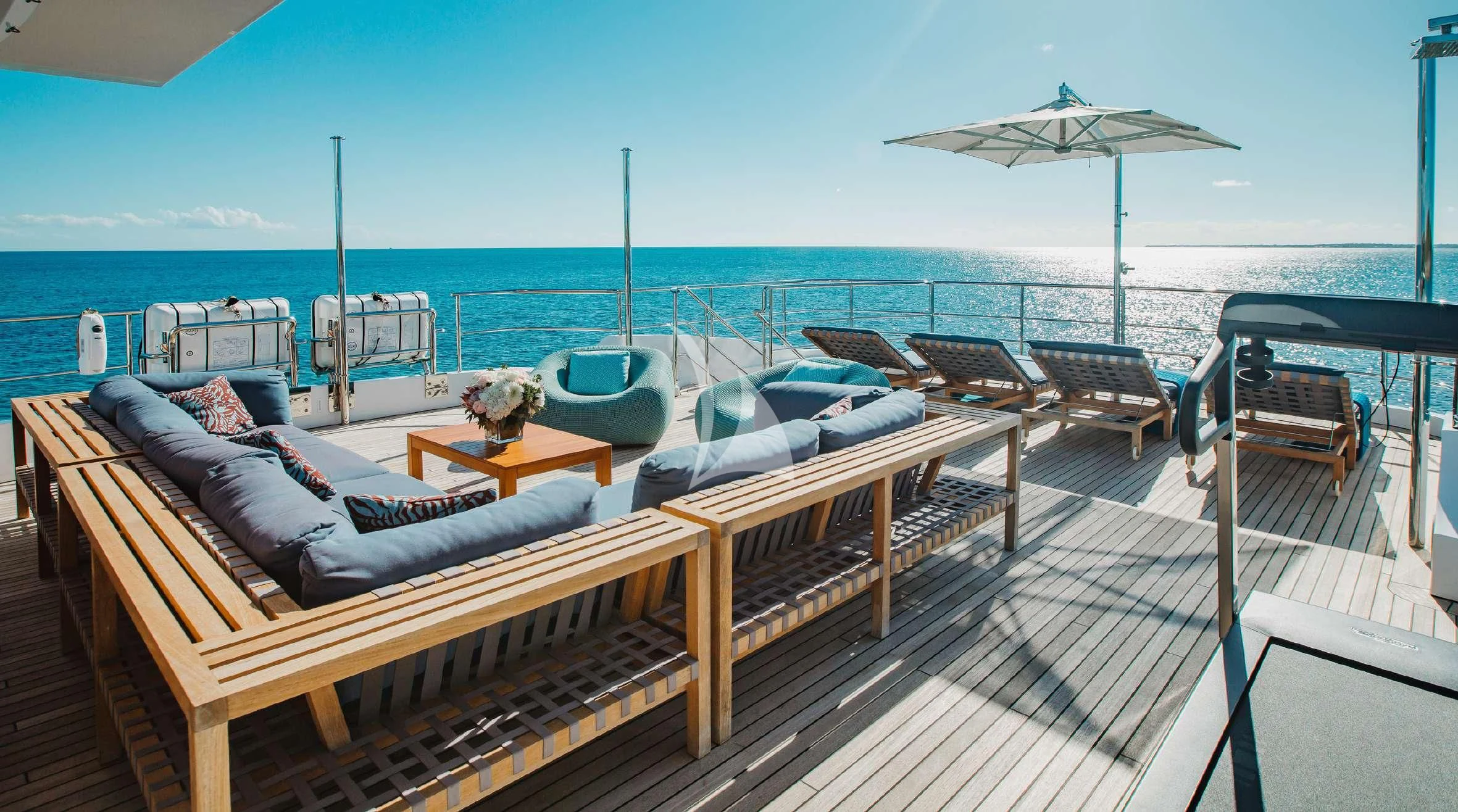 a deck with a view of the ocean and a beach aboard COFINA Yacht for Sale