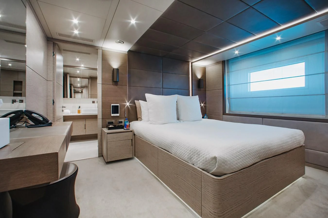 a room with a bed and a desk aboard COFINA Yacht for Sale