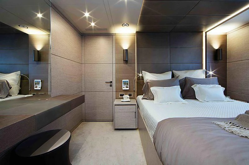 a room with a bed and a mirror aboard COFINA Yacht for Sale