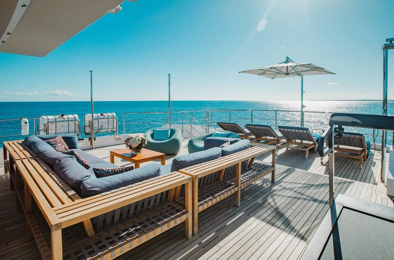 a deck with a view of the ocean and a beach aboard COFINA Yacht for Sale