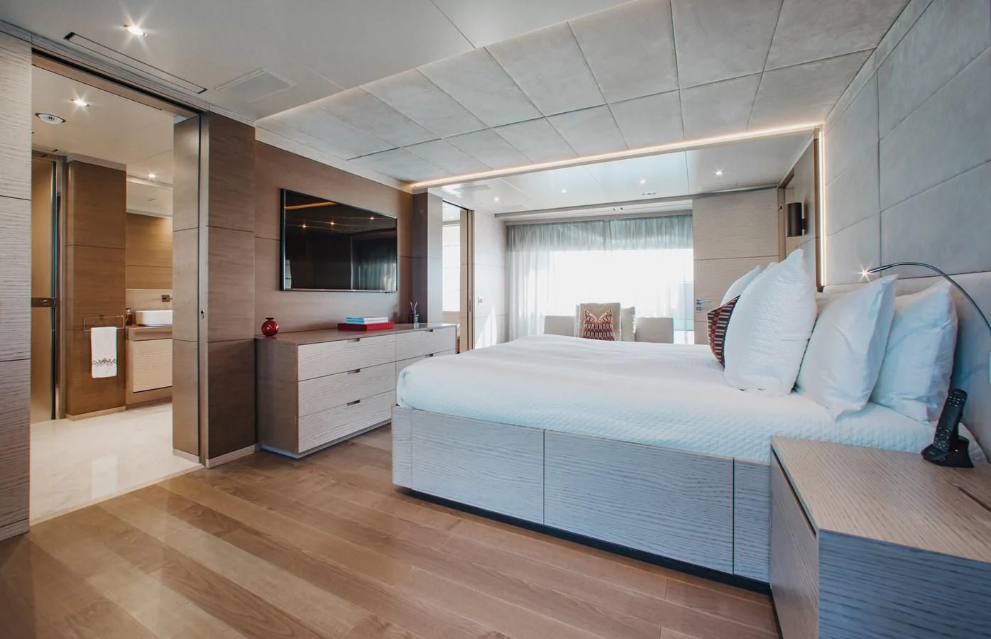 a bedroom with a bed and a desk aboard COFINA Yacht for Sale