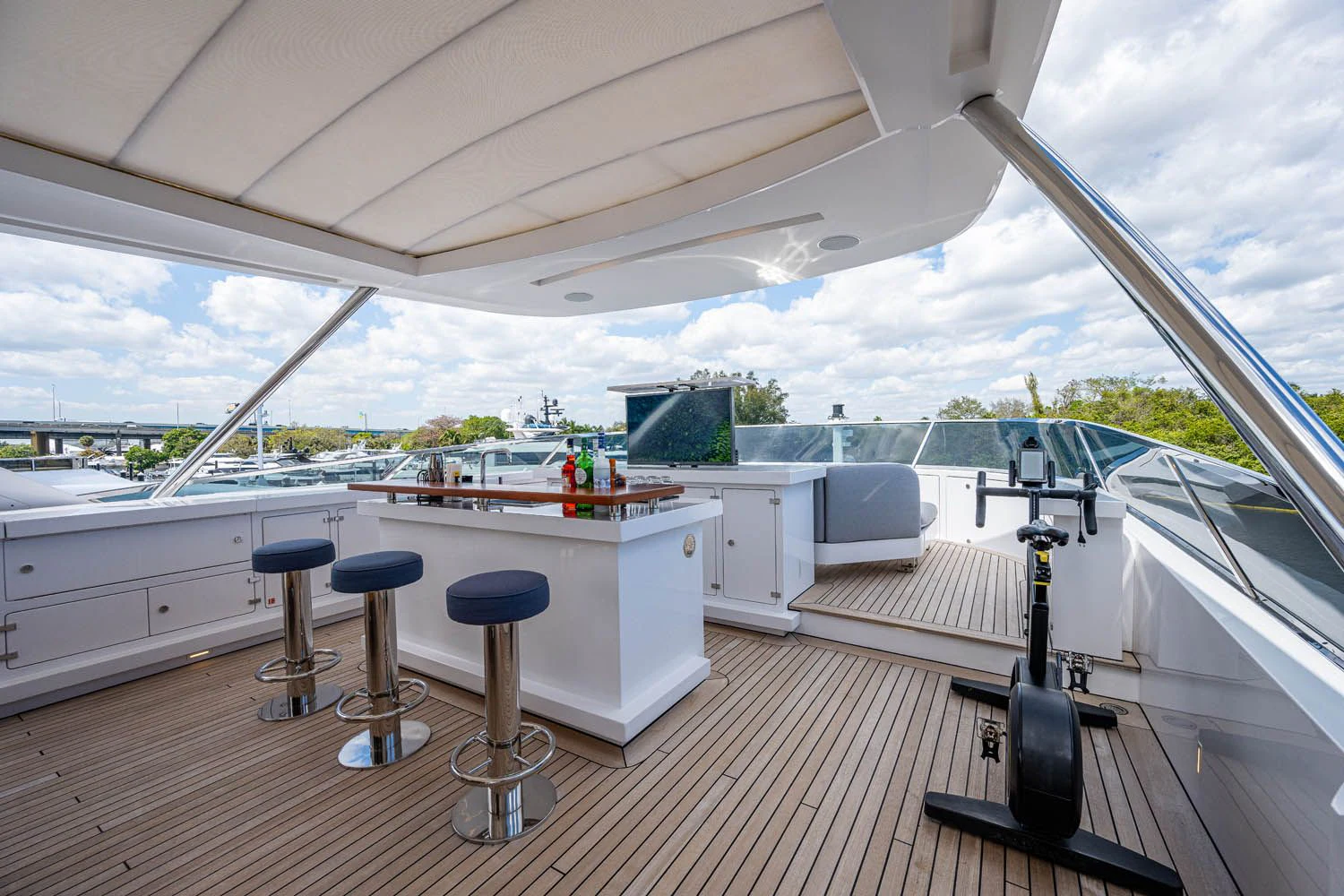 a large white boat with stools and stools on a deck aboard COFINA Yacht for Sale