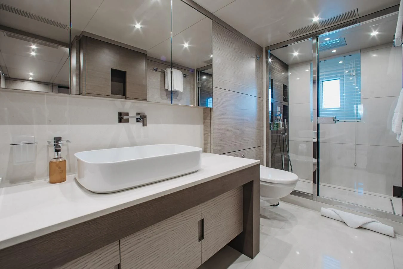 a bathroom with a glass shower aboard COFINA Yacht for Sale
