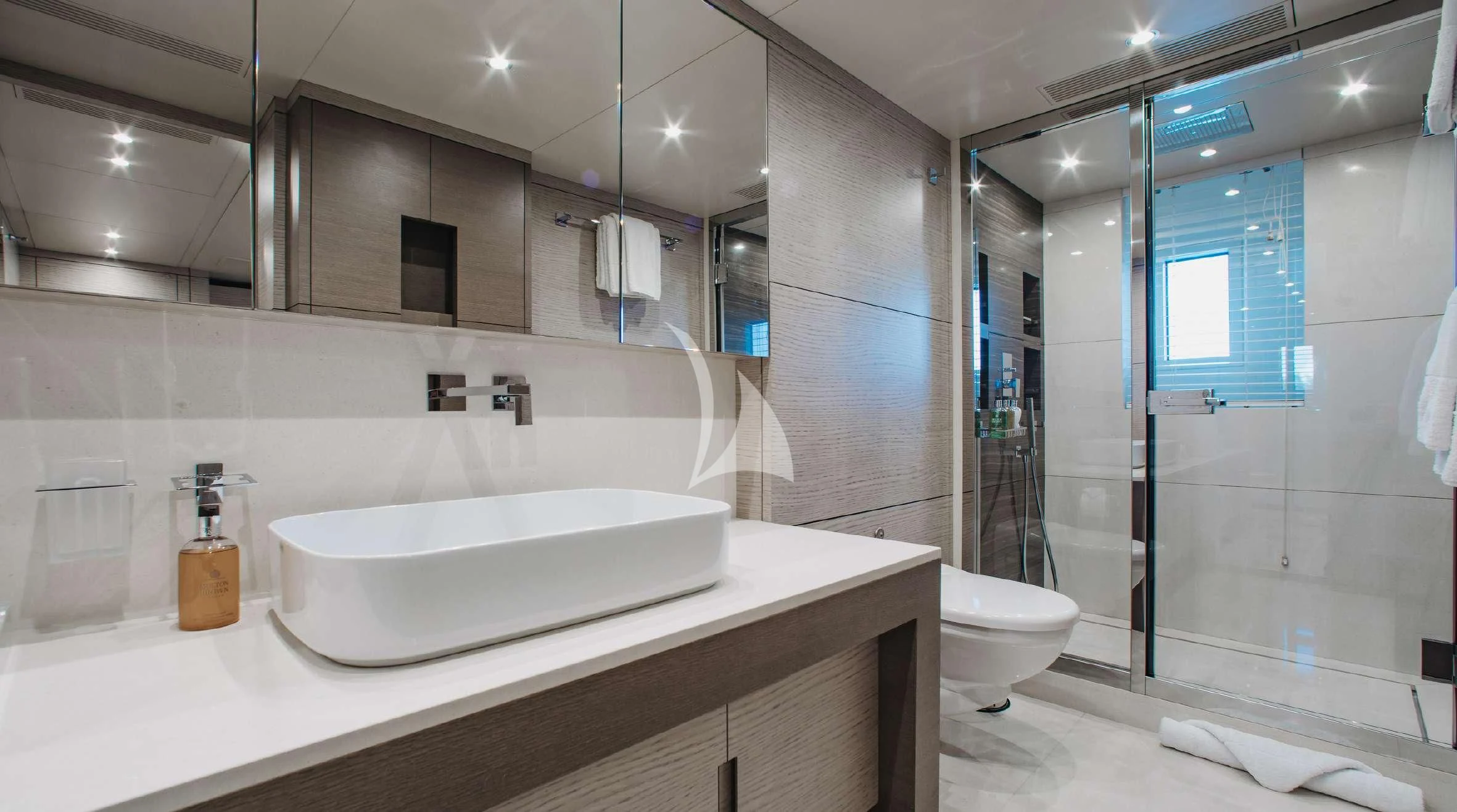 a bathroom with a glass shower aboard COFINA Yacht for Sale