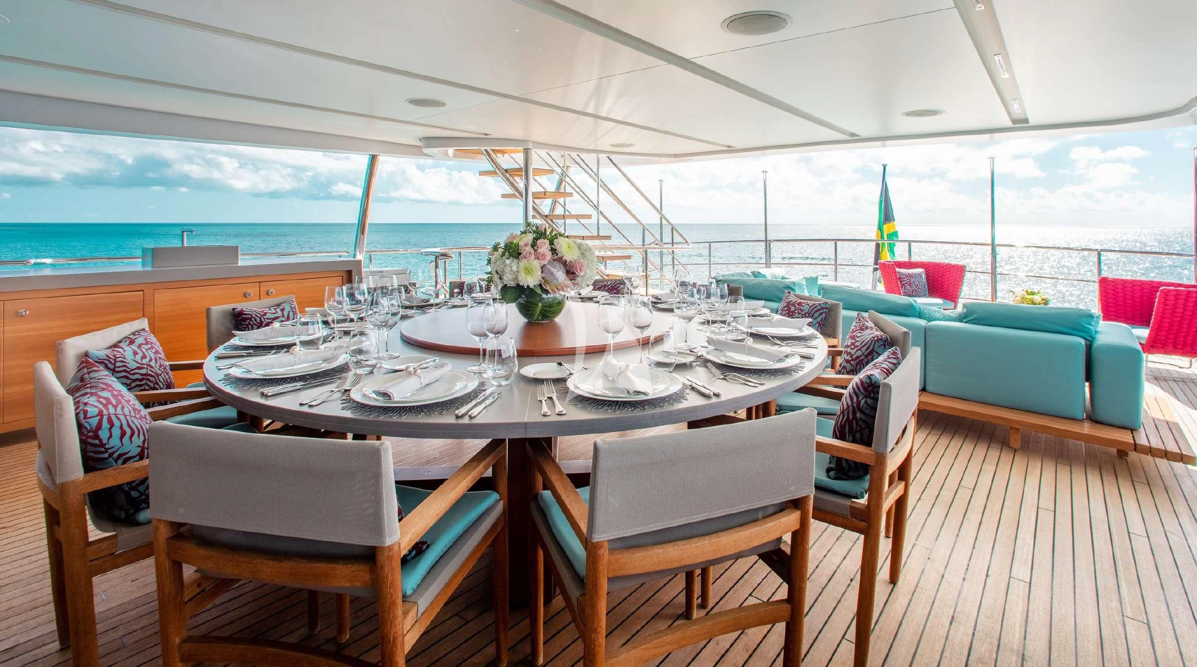 a table set for a meal on a deck aboard COFINA Yacht for Sale