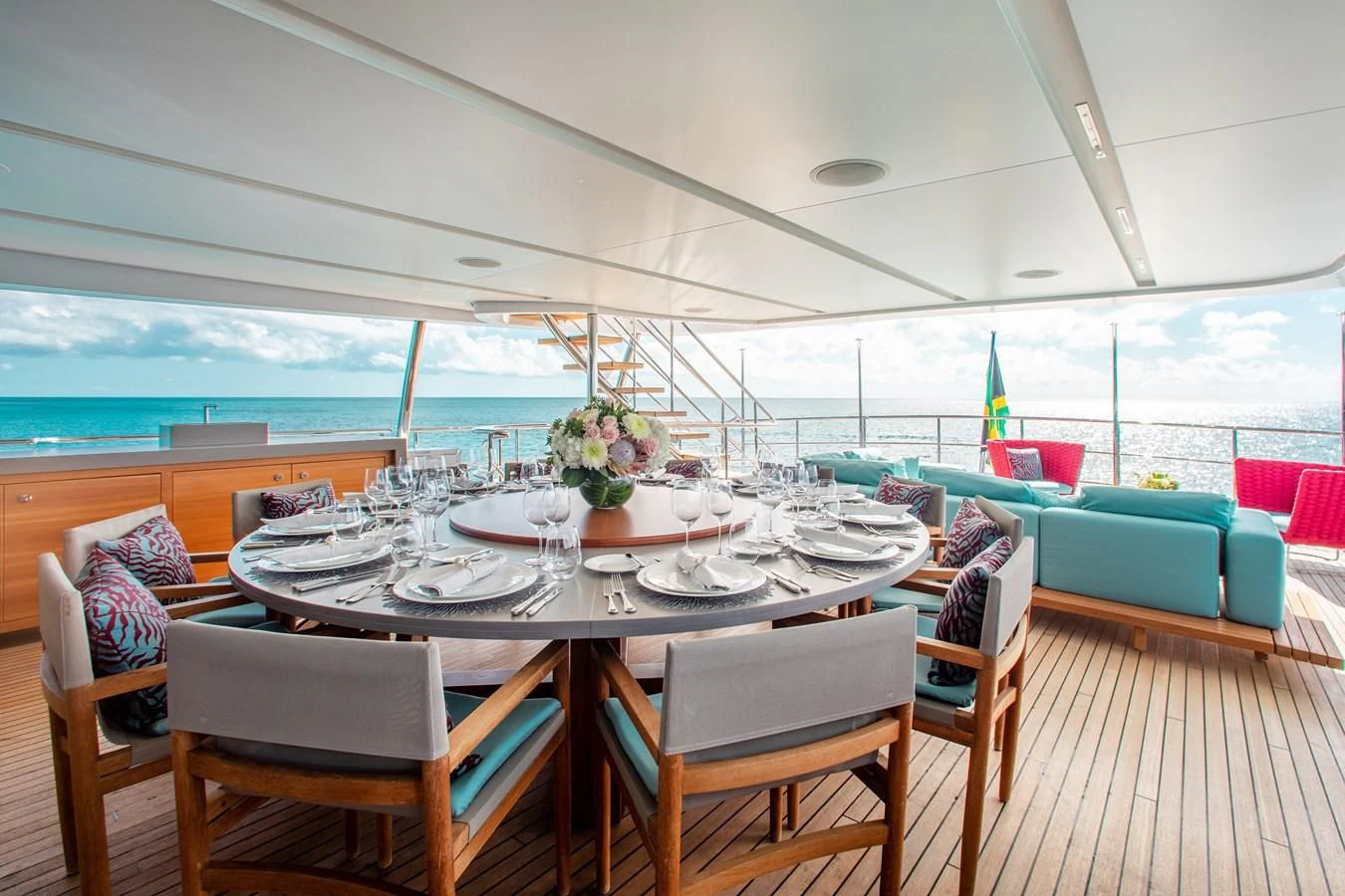 a table set for a meal on a deck aboard COFINA Yacht for Sale