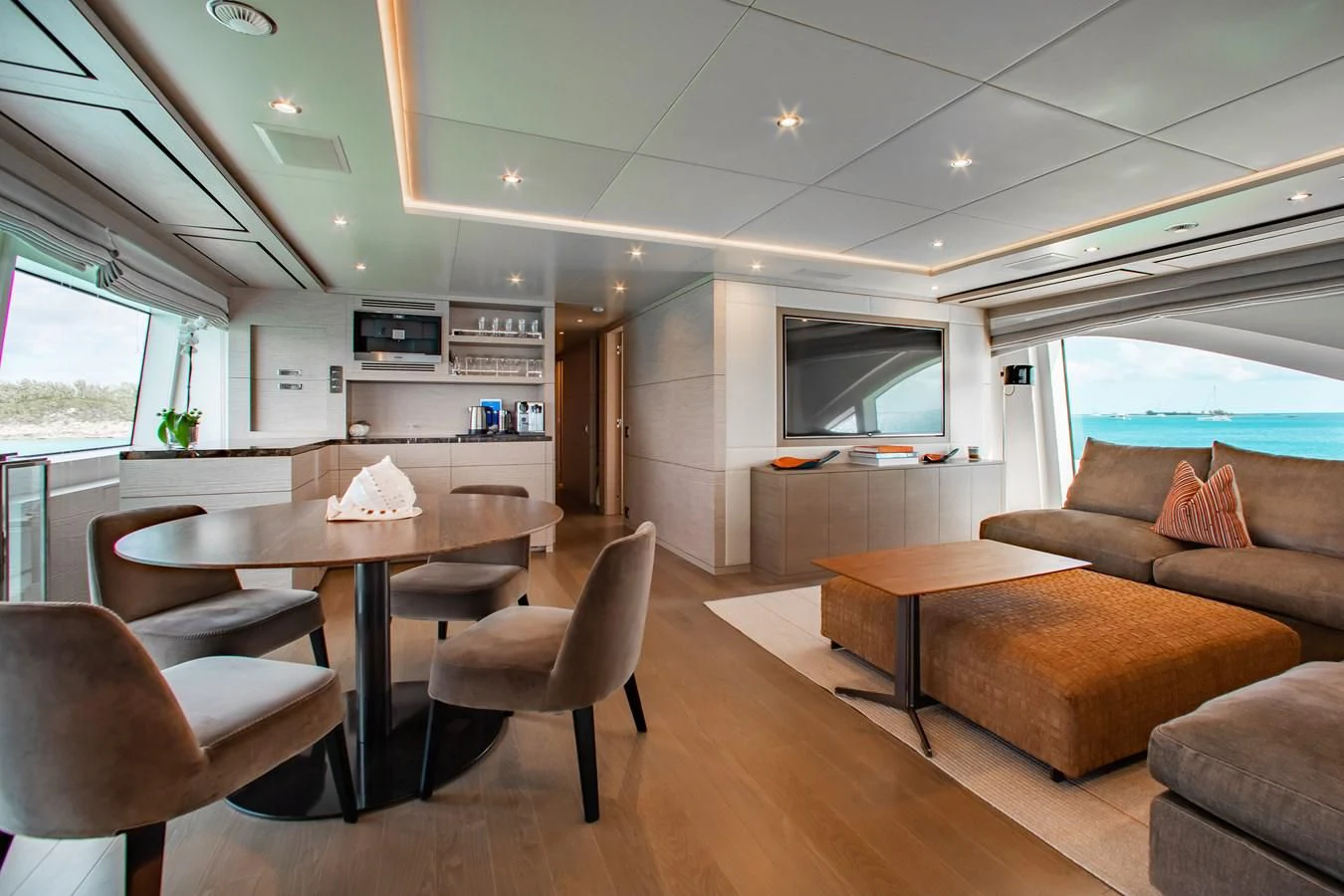 a living room with a table and chairs aboard COFINA Yacht for Sale