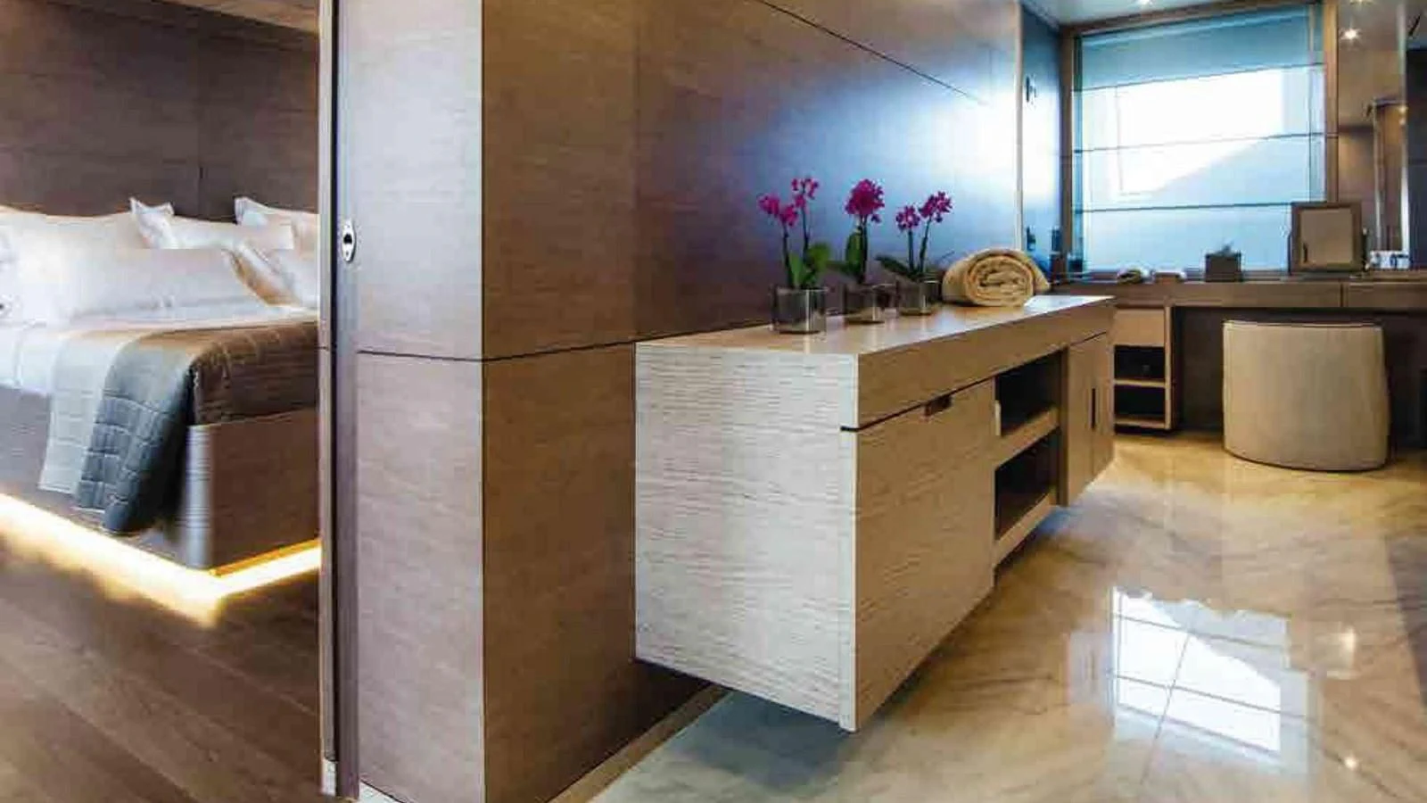 a room with a bed and desk aboard COFINA Yacht for Sale
