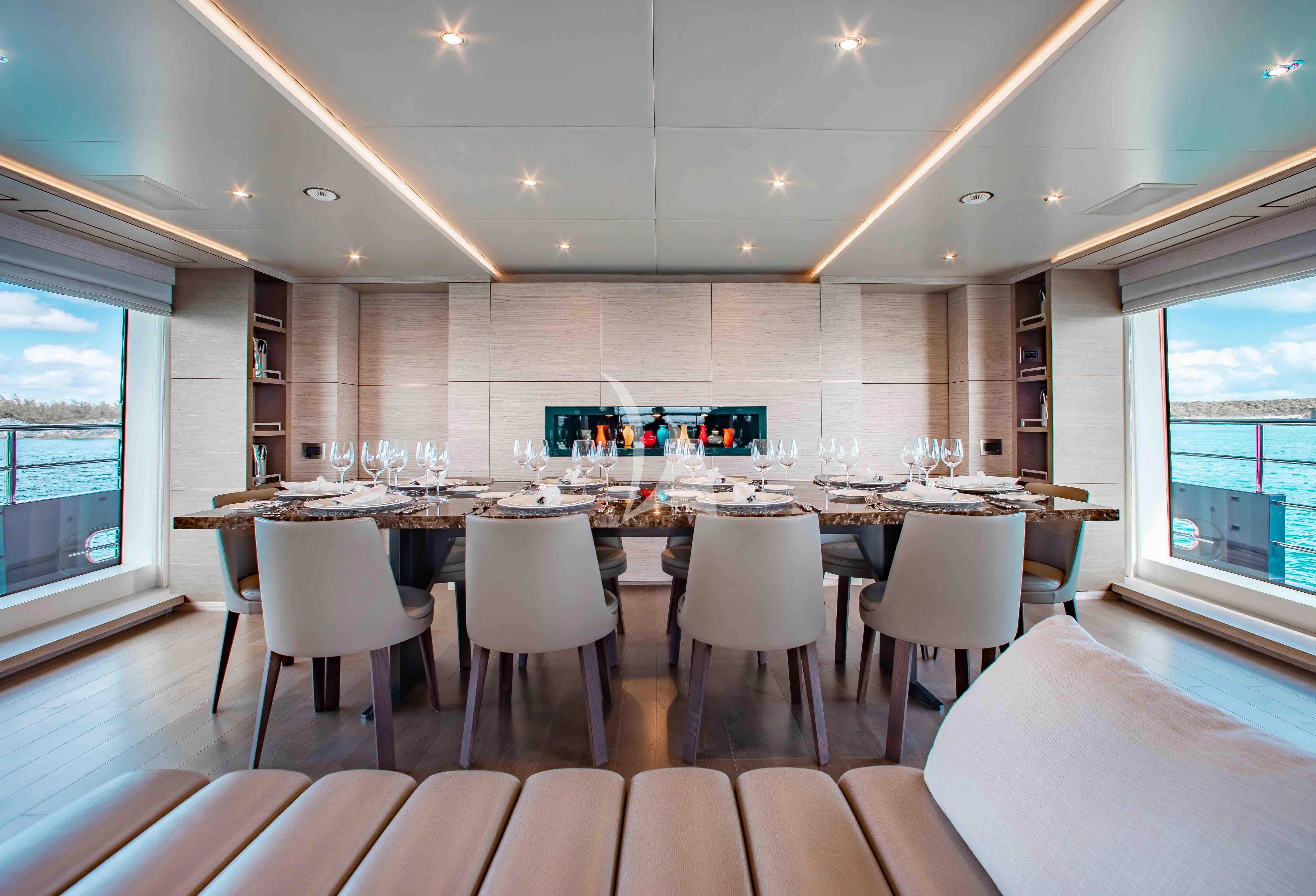 a large room with tables and chairs aboard COFINA Yacht for Sale