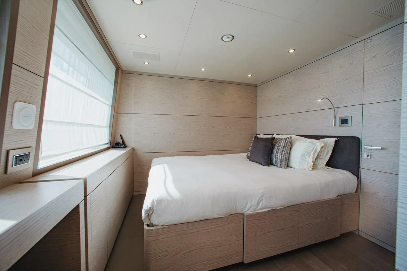 a room with a bed and a window aboard COFINA Yacht for Sale