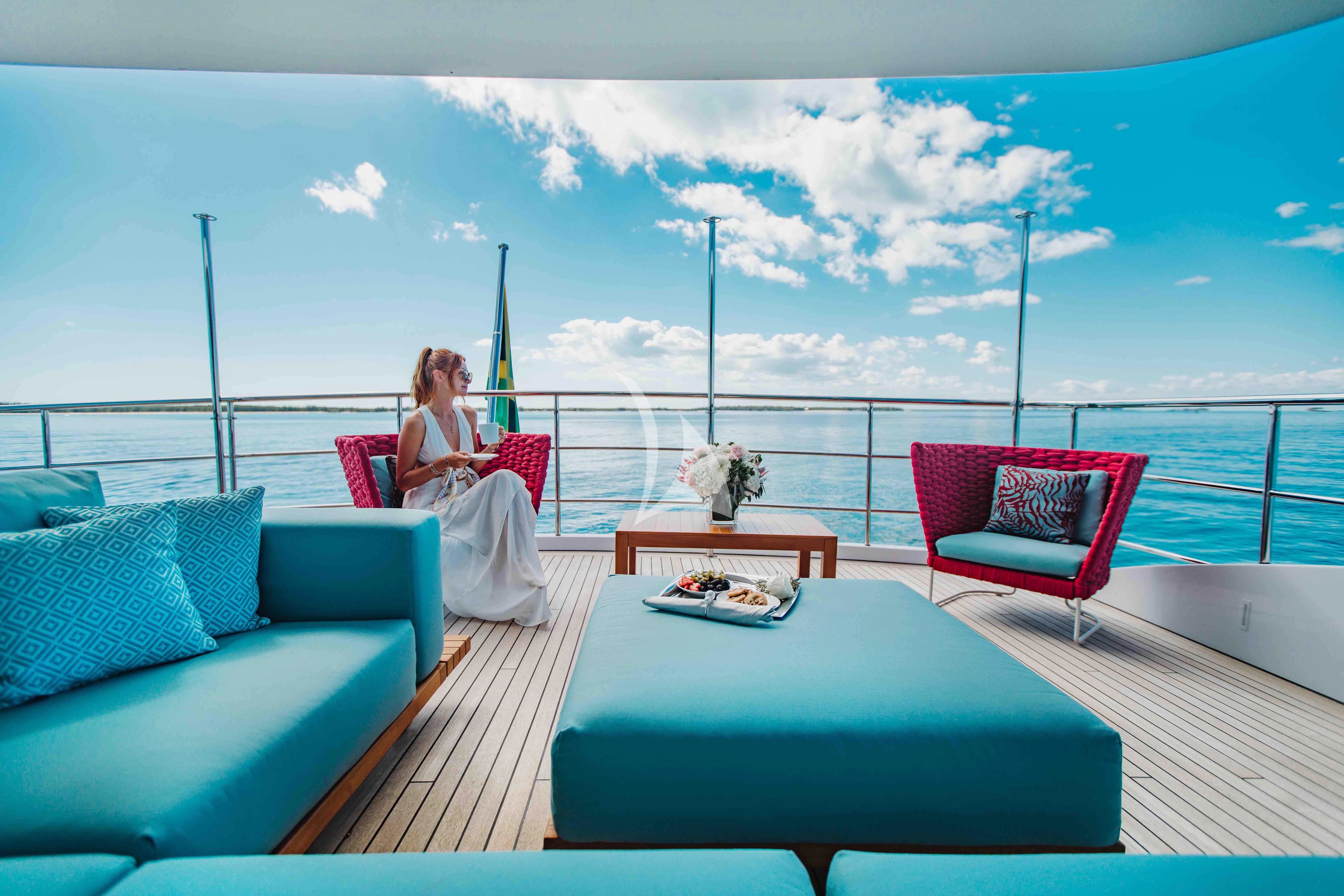 a person sitting on a deck overlooking the ocean aboard COFINA Yacht for Sale
