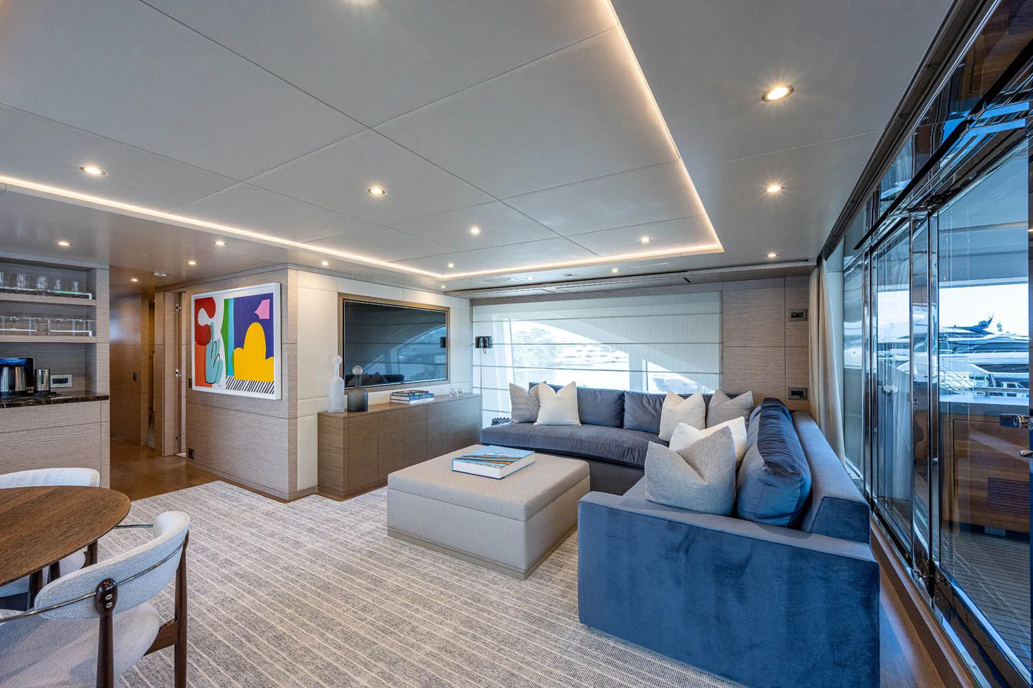 a living room with a large window aboard COFINA Yacht for Sale