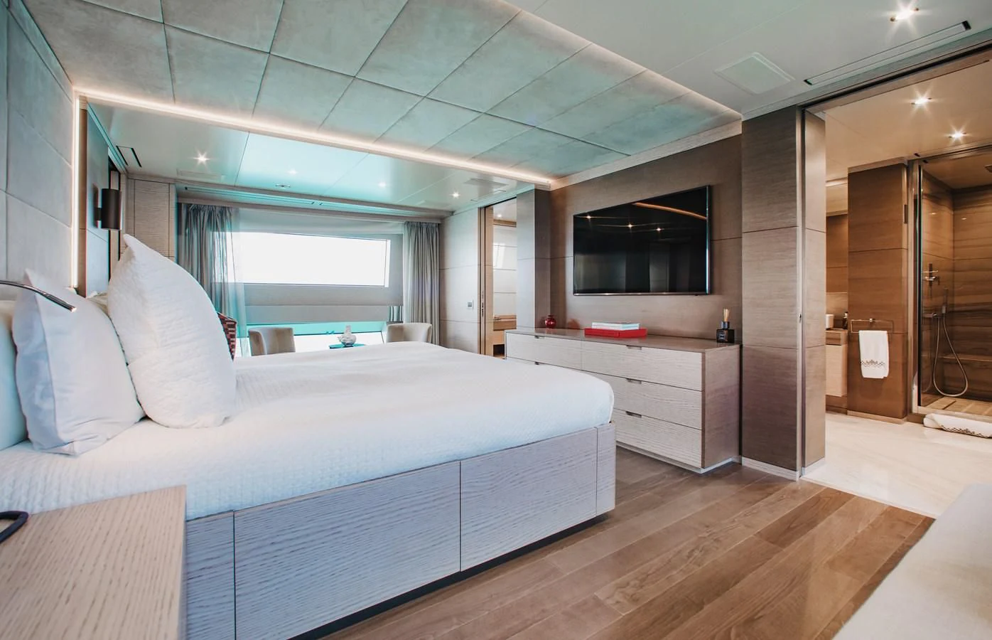 a bedroom with a bed and a desk aboard COFINA Yacht for Sale