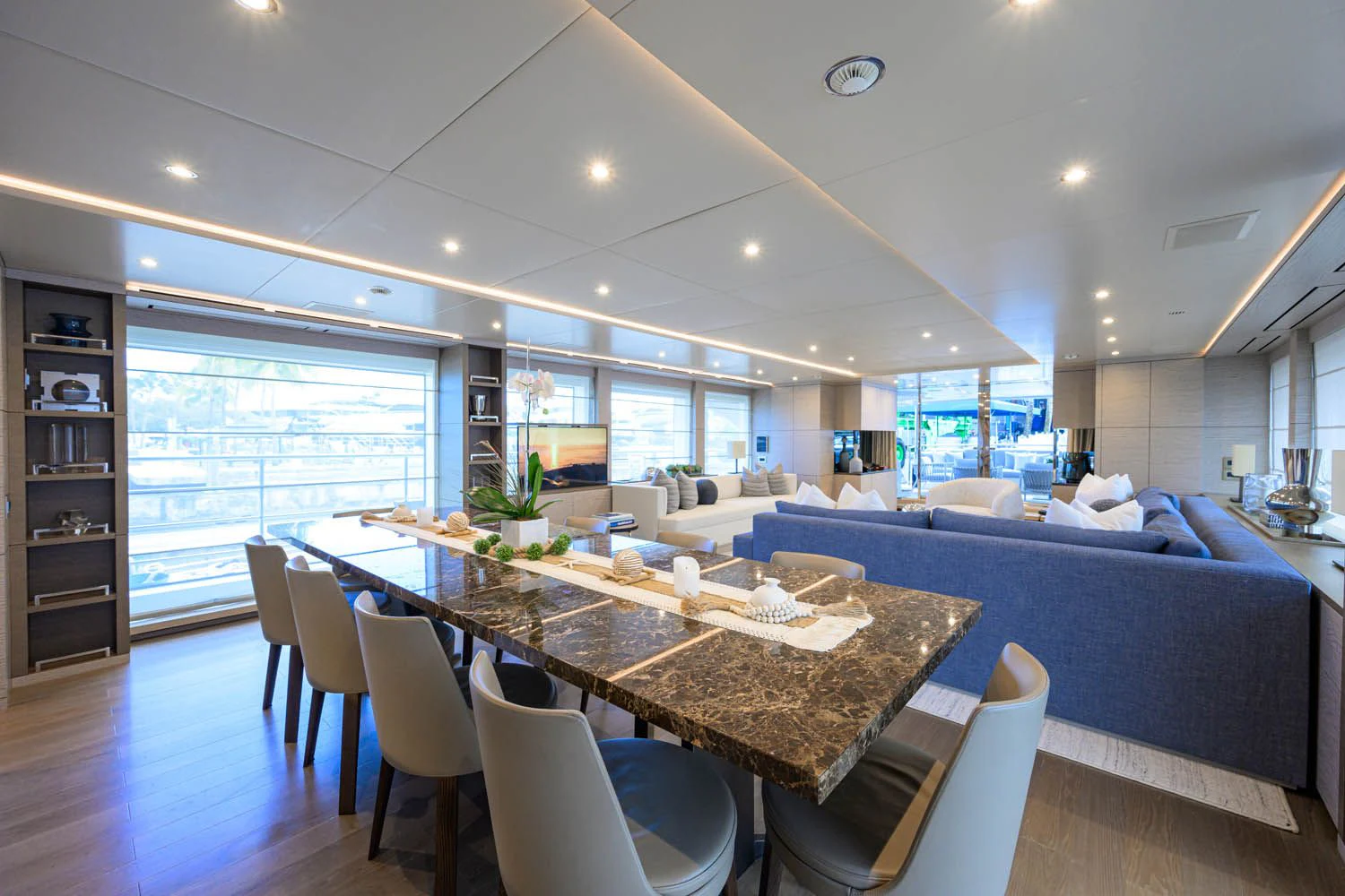 a large room with a table and chairs aboard COFINA Yacht for Sale