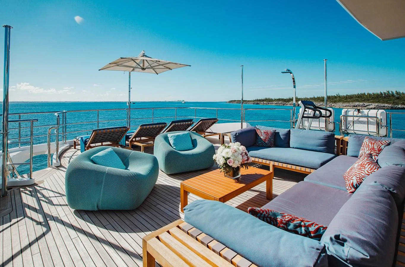 a large patio with a large body of water and a large umbrella aboard COFINA Yacht for Sale